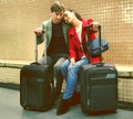 Young passengers with luggage waiting for train at subway station Royalty Free Stock Photo