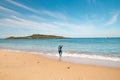 Young, passionate black-haired dobby runs from the waves of the Atlantic Ocean on a sandy beach near Porto Covo, Portugal