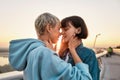 Young passionate lesbian couple going to kiss, Two women enjoying romantic moments together at sunrise