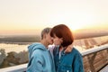 Young passionate lesbian couple kissing outdoors, Two women enjoying romantic moments together at sunrise