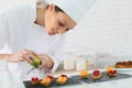 Young pastry cook preparing desert Royalty Free Stock Photo