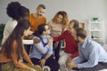 Young patient accepting help from diverse men and women in a group therapy session Royalty Free Stock Photo