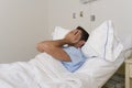 Young patient man lying at hospital bed resting tired looking sad and depressed worried Royalty Free Stock Photo