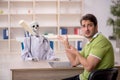 Young male patient visiting skeleton doctor Royalty Free Stock Photo