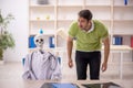 Young male patient visiting skeleton doctor Royalty Free Stock Photo