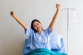 Young patient woman lying at hospital bed with saline sign for cheerful. Drop of saline solution to help patient Royalty Free Stock Photo