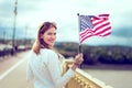 Young patriot modern woman waving USA flag