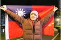 Young patriotic man holding flag of Taiwan