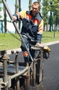 Young paver worker at asphalting