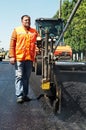 Young paver worker at asphalting