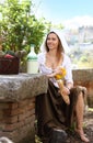 Young peasant girl sat down for a picnic