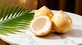 Young peeled coconuts with palm leaf on white marble table Royalty Free Stock Photo