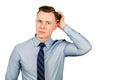 Young pensive businessman dressed in blue shirt and tie think, isolated on white background