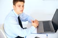 Young pensive businessman at his workplace in office Royalty Free Stock Photo