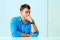 Young pensive businessman sitting at the table Royalty Free Stock Photo