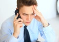 Young pensive businessman talking on cell phone Royalty Free Stock Photo