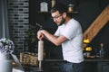 Young pensive caucasian bearded man is looking at food recipes in a laptop Royalty Free Stock Photo