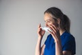 Young pensive caucasian female surgeon putting on or taking off her face mask. Royalty Free Stock Photo