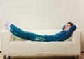 Young pensive man relaxing on couch Royalty Free Stock Photo