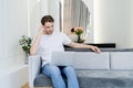 young pensive man sitting on couch Royalty Free Stock Photo