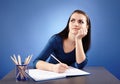 Young pensive student sitting at her desk Royalty Free Stock Photo