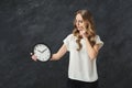 Young pensive woman holding clocks Royalty Free Stock Photo