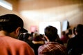 Young people attending a business conference meeting, unfocused background