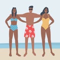 Young people in beach suits stand on the seashore. Young women and young man in swimsuits and swimming trunks are standing