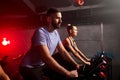 Young people biking in spinning class at modern gym Royalty Free Stock Photo