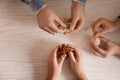 Young people with brain teasers at wooden table