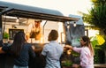 Young people buying meal from street food truck Royalty Free Stock Photo