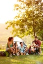 Young people on camping trip to play and sing Royalty Free Stock Photo