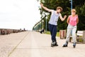 Young people casually rollblading together.