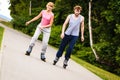 Young people casually rollblading together.