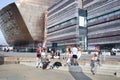 Young people chatting at The Roald Dahl Plass at Cardiff Bay, Cardiff in the UK