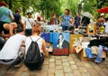 Young people choosing books, draws, portrait of Johnny Cash on street market