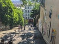 Young people climb outdoor stairs on Montmartre, Paris, on summer day Royalty Free Stock Photo