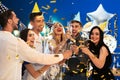 Young people clinking glasses with champagne at birthday party in club Royalty Free Stock Photo