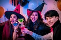 Young People in Costumes Celebrating Halloween. Group of Young Happy Friends Wearing Halloween Costumes having Fun at Party in Royalty Free Stock Photo