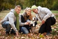 Young people with cute dog in park smiling Royalty Free Stock Photo
