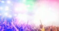 Young people dancing and having fun in summer festival party outdoor - Crowd with hands up celebrating concert event - Soft focus Royalty Free Stock Photo