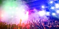 Young people dancing and having fun in summer festival party outdoor - Crowd with hands up celebrating concert event - Soft focus Royalty Free Stock Photo