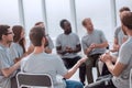 Young people are discussing something sitting in a circle. Royalty Free Stock Photo