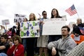 Young people display signs at tea party rally. Royalty Free Stock Photo