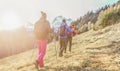 Young people doing trekking excursion in french high mountains - Hikers walking in alps with back sun light - Survival,travel and Royalty Free Stock Photo