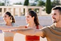 Young group of people doing yoga exercises at outside training class Royalty Free Stock Photo