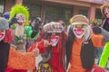 young people dressed as colorful clowns playing