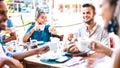 Young people drinking cappuccino at coffee house outdoor - Milenial friends having fun together at restaurant - New normal Royalty Free Stock Photo