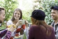 Young people drinking cappuccino and espresso coffee at cafe bar garden - Happy friends talking and having fun together at hostel Royalty Free Stock Photo