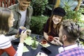 Young people drinking espresso and american coffee at cafe bar garden - Happy friends talking and having fun together at hostel Royalty Free Stock Photo